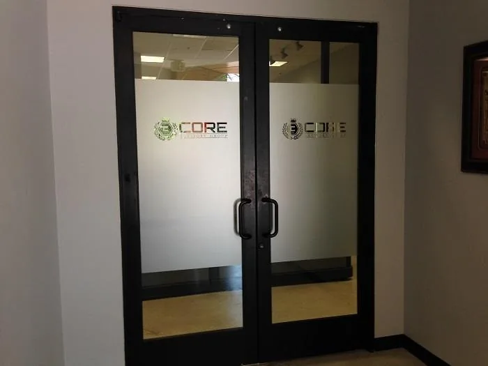Applied business logo and lettering on glass entrance doors