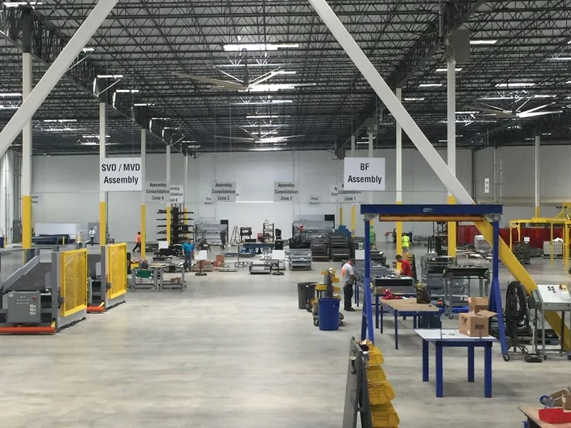 Overhead directional signs in a warehouse interior