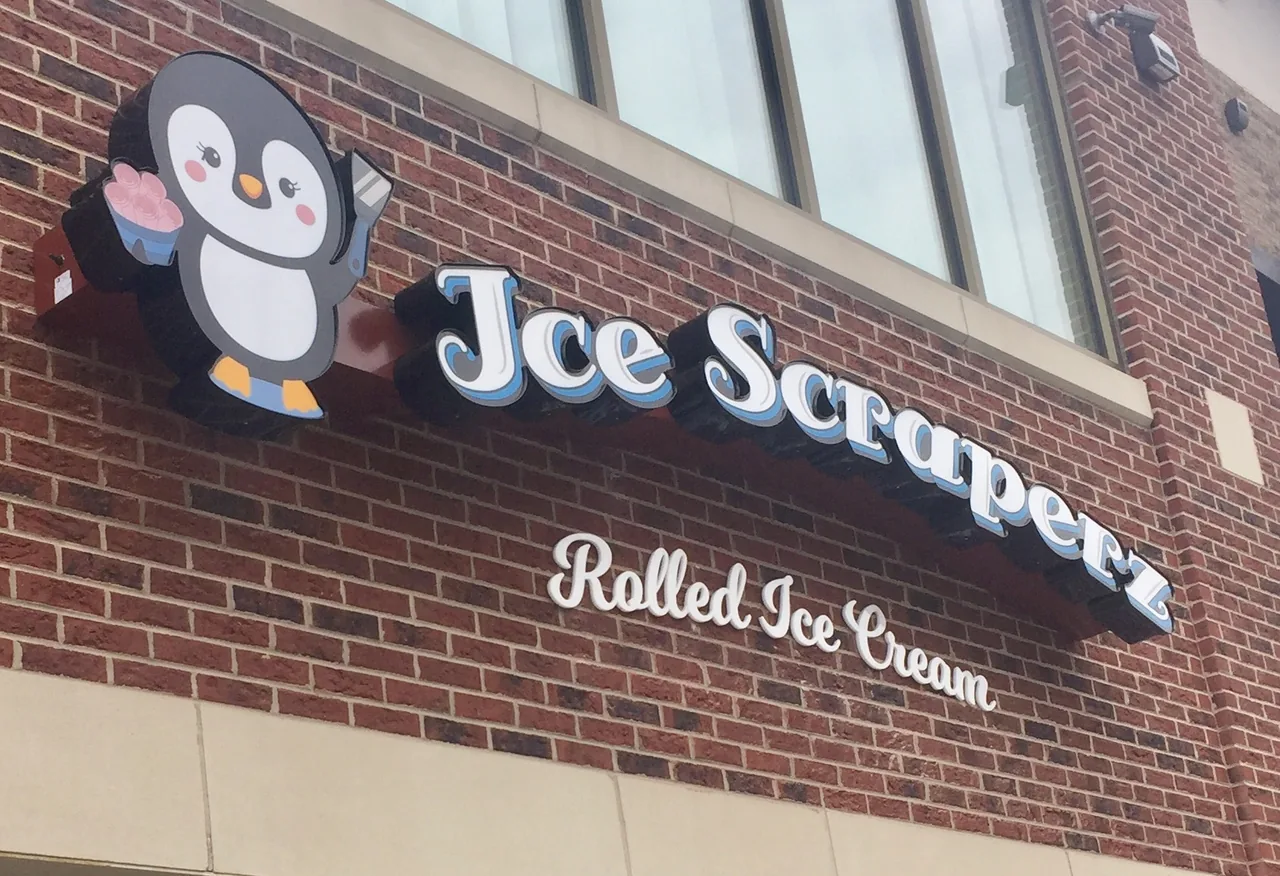 Individual channel letters and a separate logo mounted on a brick storefront
